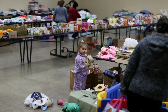 Emma Neurohr, 4, of Oroville, looks through toys from the Salvation Army relief center at the Placer County Fairgrounds in Roseville, California, after an evacuation was ordered for communities downstream from the dam in Oroville, California, U.S. February 14, 2017. (Photo by Beck Diefenbach/Reuters)