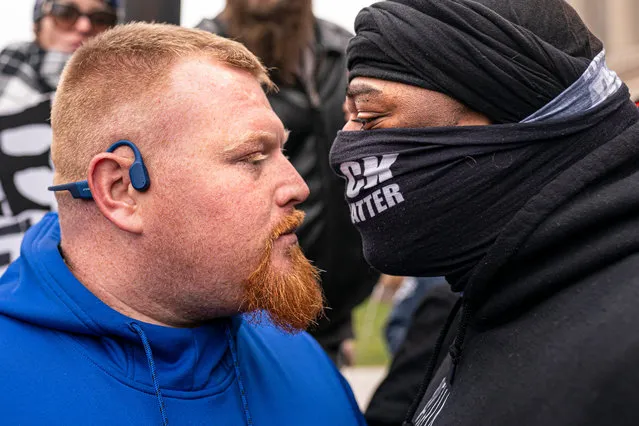 A supporter of Kyle Rittenhouse (L) argues with a Black Lives Matter supporter in front of the Kenosha County Courthouse while the jury deliberates the Rittenhouse trial on November 16, 2021 in Kenosha, Wisconsin. Rittenhouse is accused of shooting three demonstrators, killing two of them, during a night of unrest that erupted in Kenosha after a police officer shot Jacob Blake seven times in the back while being arrested in August 2020. Rittenhouse, from Antioch, Illinois, was 17 at the time of the shooting and armed with an assault rifle. He faces counts of felony homicide and felony attempted homicide. (Photo by Nathan Howard/Getty Images)