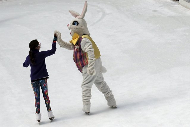 The Easter Bunny gives a high-five while skating at The Rink at Rockefeller Center in New York City March 27, 2016. (Photo by Brendan McDermid/Reuters)