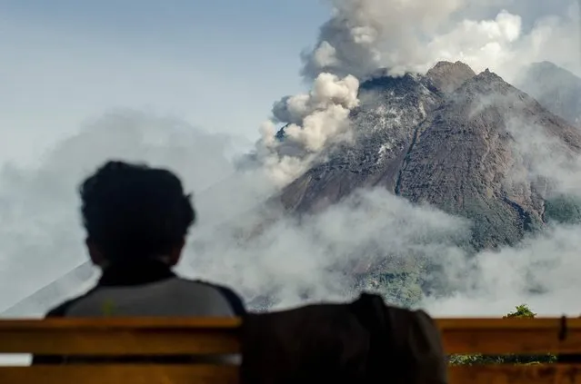 A villager looks at Mount Merapi, Indonesia's most active volcano, as seen from Sleman, on December 2, 2021. (Photo by Agung Supriyanto/AFP Photo)