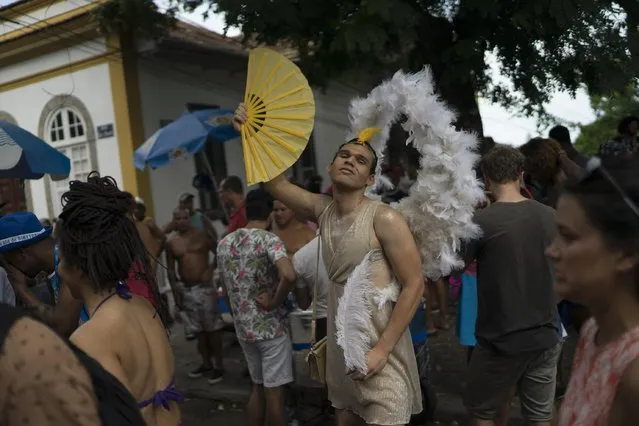 A reveler in costume poses for the photo during the Carmelitas street party in Rio de Janeiro, Brazil, Friday, February 24, 2017. (Photo by Leo Correa/AP Photo)