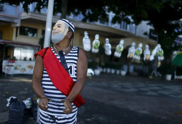 A demonstrator wearing a mask depicting Brazil's former President Luiz Inacio Lula da Silva takes part in a protest against Brazilian President Dilma Rousseff in Rio de Janeiro Brazil, April 17, 2016. (Photo by Pilar Olivares/Reuters)