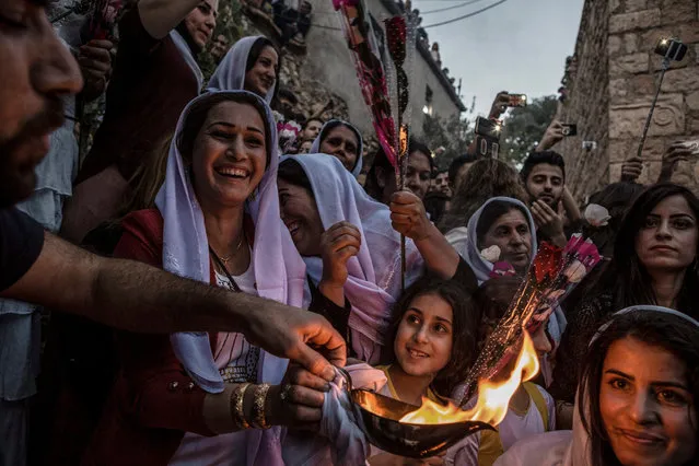 Yazidis gather at the shrine of Sheikh Adi ibn Musafir to celebrate their new year with the lighting of candles in Lalish, north of Mosul, Iraq, 19 April 2016. Iraq has the biggest population of Yazidis worldwide with Lalish being their principal holy site. (Photo by Andrea Dicenzo/EPA)