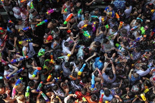 Locals and tourists play with water as they celebrate the Songkran holiday which marks the Thai New Year in Bangkok, Thailand, on April 13, 2024. (Photo by Chalinee Thirasupa/Reuters)