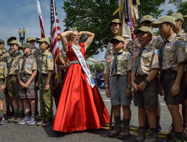 Miss Washington D.C., Katelynne Cox, makes a funny face while posing with Boy Scout troop 55 before the start of the National Independence Day Parade in Washington, D.C. on July 4, 2019. (Photo by Bill O'Leary/The Washington Post)