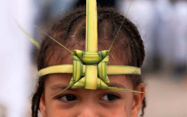 An Ethiopian Orthodox faithful girl wears a palm headband as she attends the Palm Sunday Mass at the Bole Medhanialem Orthodox church in Addis Ababa, Ethiopia on April 28, 2024. (Photo by Tiksa Negeri/Reuters)