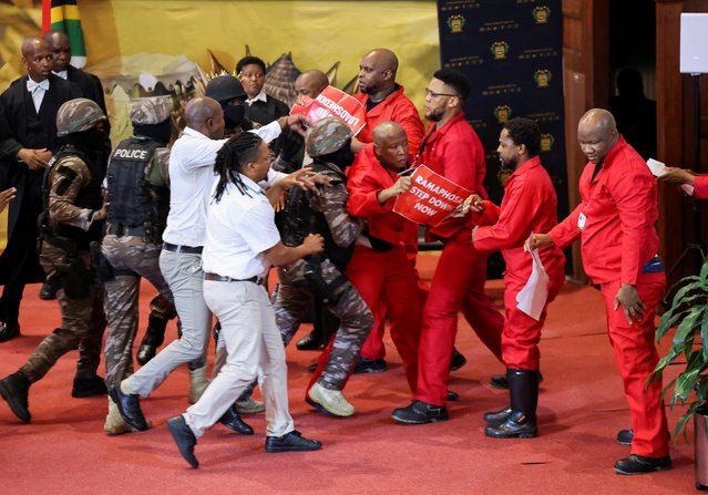 Opposition Economic Freedom Fighters party members are removed by presidential task force and parliament officials as South African President Cyril Ramaphosa attempts to deliver his 2023 state-of-the-nation address (SONA) at the Cape Town City Hall in Cape Town on February 9, 2023. (Photo by Esa Alexander/Pool via AFP Photo)