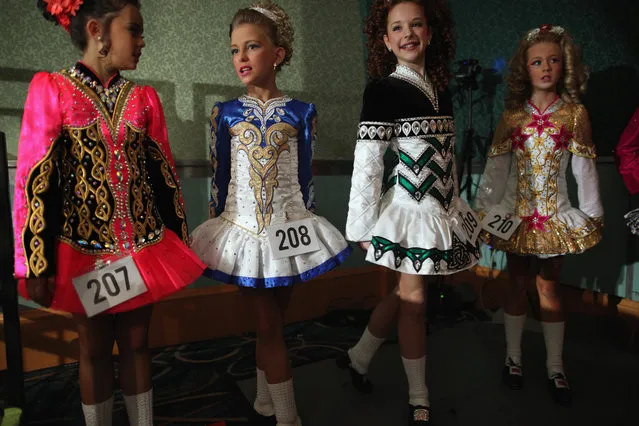 Competitors in an 11/12 yrs old Girls Category wait backstage to perform at the World Irish Dance Championship on April 13, 2014 in London, England. The 44th World Irish Dance Championship is currently running at London's Hilton London Metropole hotel, and will host approximately 5,000 dancers competing in solo, Ceili, modern figure choreography and dance drama categories during the week long event. (Photo by Dan Kitwood/Getty Images)
