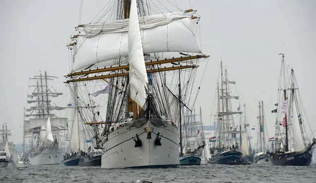 Sailing ships take part at the traditional tall ship parade of the Kiel Week sailing event on the Baltic sea in Kiel, northern Germany, Saturday, June 27, 2015. (Photo by Carsten Rehder/DPA via AP Photo)