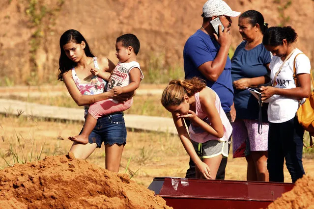 Rita Mota, center, says goodbye during the funeral of her brother who was killed during a riot at a prison in Altamaria, Para state, Brazil, Wednesday, July 31, 2019. At least 57 prisoners were killed by other inmates during clashes between organized crime groups in the Altamira prison in northern Brazil Monday with 16 of the victims being decapitated, according to prison officials. (Photo by Raimundo Pacco/AP Photo)