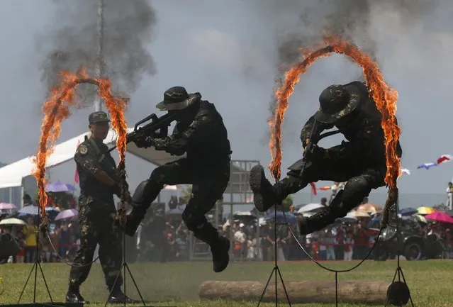 Chinese People's Liberation Army (PLA) personnel demonstrate during the open day of Stonecutter Island Navy Base in Hong Kong to mark the 18th anniversary of the Hong Kong handover to China in Hong Kong, Wednesday, July 1, 2015. (Photo by Kin Cheung/AP Photo)