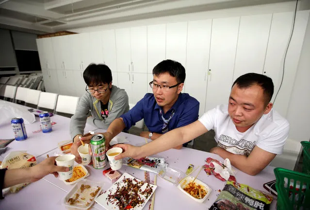 Han Liqun (C), a HR manager of RenRen Credit Management Co., drinks with his colleagues Kou Meng (L) and Ma Zhenguo after finishing work, after midnight, in Beijing, China, April 27, 2016. Office workers sleeping on the job is a common sight in China, where a surplus of cheap labour can lead to downtime at work. But in China's technology sector, where business is growing faster than many start-up firms can hire new staff, workers burn the midnight oil to meet deadlines and compete with their rivals. Some companies provide sleeping areas and beds for workers to rest during late nights. (Photo by Jason Lee/Reuters)