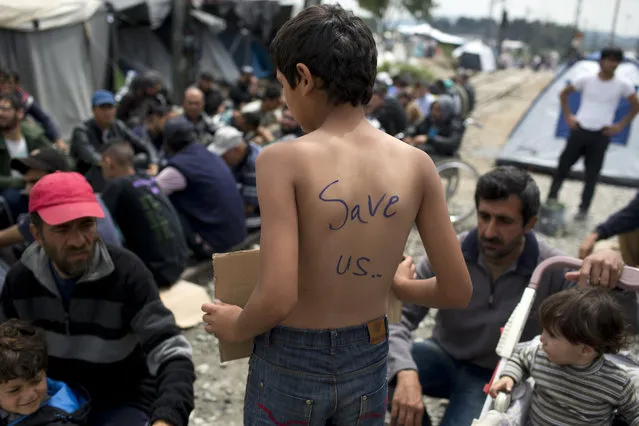 Refugees and migrants take part in a peaceful protest at a makeshift refugee camp of the northern Greek border point of Idomeni, Greece, on Thursday, May 12, 2016. About 54,000 people are currently stranded in Greece, after the European Union and Turkey reached a deal designed to stem the flow of refugees into Europe's prosperous heartland. (Photo by Petros Giannakouris/AP Photo)