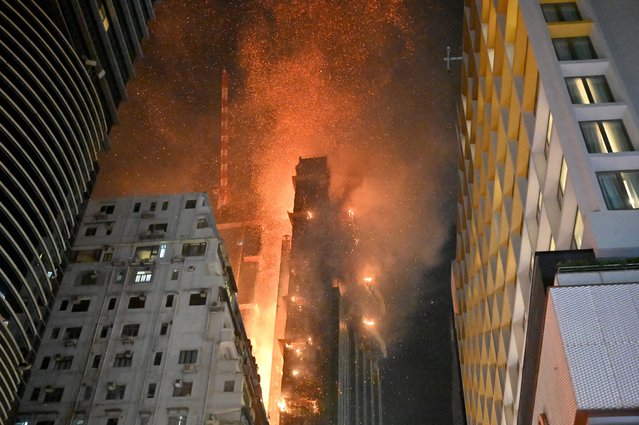 A fire breaks out in an office building in Tsim Sha Tsui, in Hong Kong on early March 3, 2023. (Photo by Peter Parks/AFP Photo)