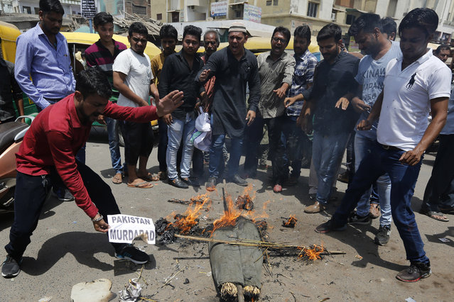 Indians burn an effigy of Pakistan and shout anti-Pakistan slogans during a protest in Ahmadabad, India, Wednesday, May 3, 2017. Two Indian soldiers were killed and their bodies mutilated Monday in an ambush by Pakistani soldiers along the highly militarized de facto border that divides the disputed region of Kashmir between the nuclear-armed rivals, the Indian army said. But Pakistan denied any such attack, calling the Indian claims false. (Photo by Ajit Solanki/AP Photo)