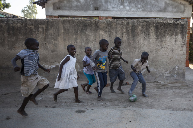 Zimbabwean children play with a ball, made with putting together pieces of papers, after their school during their daily lives in Harare, Zimbabwe on May 13, 2019. (Photo by Mustafa Kamaci/Anadolu Agency/Getty Images)