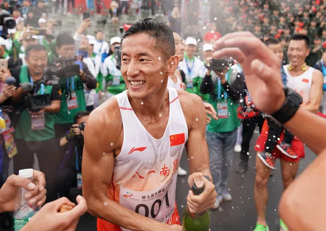 Pan Yucheng celebrates after the cross-country competition of military pentathlon at the seventh Military World Games in Hubei province, China on October 23, 2019. (Photo by Xinhua News Agency/Rex Features/Shutterstock)
