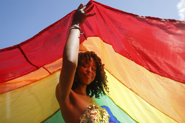 A reveler takes part in a Gay Pride march in Caracas, Venezuela, Sunday, July 7, 2024. (Photo by Cristian Hernandez/AP Photo)