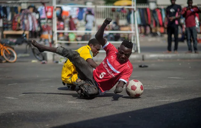Ghanaian teenagers who contracted polio and lost their walking ability, play soccer in Tudu district of Accra, Ghana on May 14, 2017. Teenagers who maintain their lives by begging for money on the traffic roads in Ghana, gather to play soccer with their skateboards every sunday. Poliomyelitis is a highly contagious disease caused by a virus that attacks the nervous system and spinal cord. Children younger than 5 years old are more likely to contract the virus than any other group and it is still endemic, along with West and Central Africa. (Photo by Jordi Perdigo/Anadolu Agency/Getty Images)