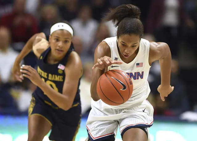 Connecticut's Megan Walker takes off with a steal from Notre Dame's Katlyn Gilbert, left, in the first half of an NCAA college basketball game, Sunday, December 8, 2019, in Storrs, Conn. (Photo by Jessica Hill/AP Photo)