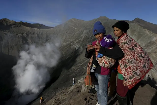 Hindu worshippers stand on top of the crater of Mount Bromo as they attend the Kasada Festival in Probolinggo, Indonesia's East Java province, August 1, 2015. (Photo by Reuters/Beawiharta)