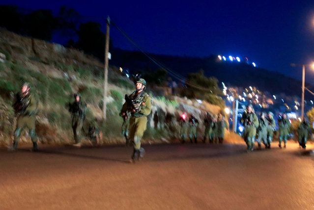 Israeli soldiers leave after a raid at the Balata refugee camp in the occupied West Bank city of Nablus early on May 22, 2023. Three Palestinian fighters were killed in an overnight Israeli army raid in the occupied West Bank, according to Palestinian sources. (Photo by Zain Jaafar/AFP Photo)