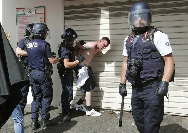 Football Soccer, Euro 2016, England vs Russia, Group B, Stade Velodrome, Marseille, France on June 11, 2016. Police detain an injured supporter near port of Marseille before the game. (Photo by Jean-Paul Pelissier/Reuters)