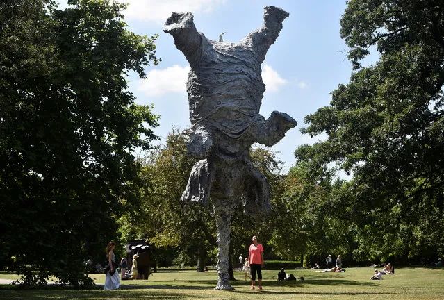 A woman views Miquel Barcelo's sculpture “Gran Elefandret” at the Frieze Sculpture exhibition in London, Britain, July 5, 2017. (Photo by Hannah McKay/Reuters)