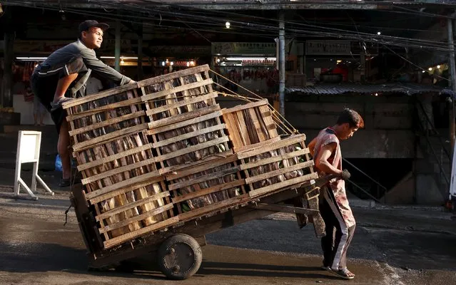 Workers transport crates containing bananas on a wooden cart at a food market in the mountain resort of Baguio city in northern Philippines April 17, 2016. (Photo by Erik De Castro/Reuters)
