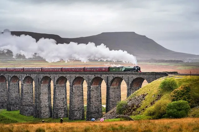 The Peppercorn A1 Pacific class 60163 Tornado steam locomotive hauls a special train over the Ribblehead viaduct as it travels through the Yorkshire Dales on its journey from Preston to Carlisle, United Kingdom on Wednesday, October 20, 2021. (Photo by Danny Lawson/PA Wire Press Association)