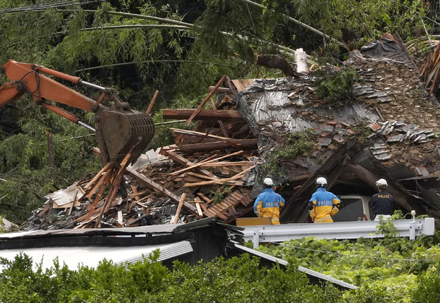 Police officers stand during a rescue operation at an area affected by landfall due to heavy rains caused by Typhoon Shanshan in Gamagori, Aichi prefecture, Japan, on August 29, 2024, in this photo taken by Kyodo News. (Photo by Kyodo via Reuters)