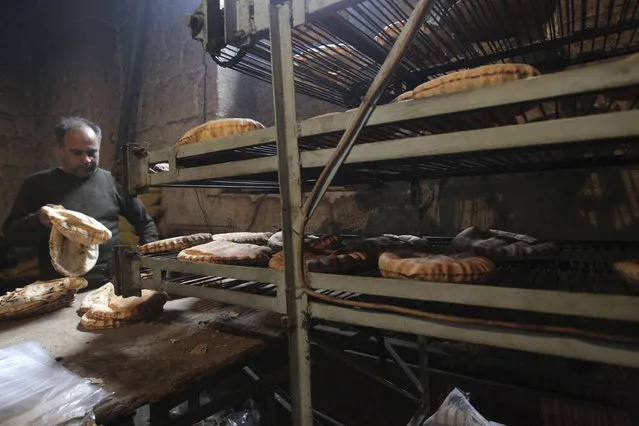 A man works at a bakery in Aleppo city December 30, 2013. (Photo by Jalal Alhalabi/Reuters)