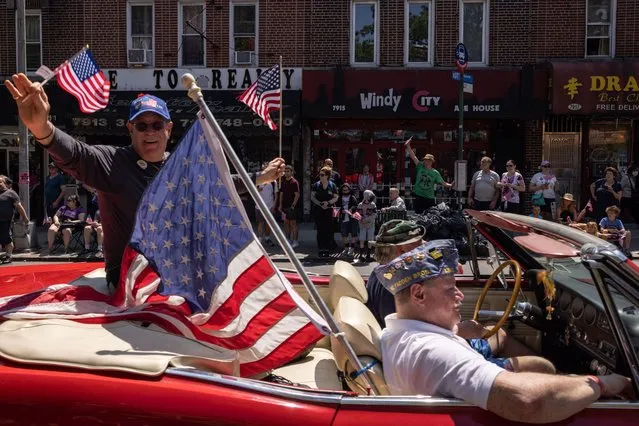 Veterans wave American flags as they participate in the 155th Brooklyn's Memorial Day Parade in Brooklyn, New York, on May 30, 2022. (Photo by Yuki Iwamura/AFP Photo)