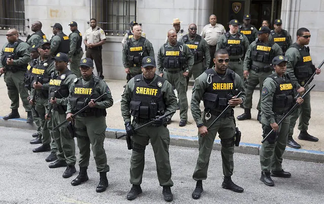Police officers stand guard outside the courthouse before a verdict was issued in the trial of police officer Caesar Goodson, one of six Baltimore police officers charged over the death of Freddie Gray, in Baltimore, Maryland, USA, 23 June 2016. A judge issued a verdict of not-guilty in all accounts in the trial of Goodson. (Photo by Michael Reynolds/EPA)