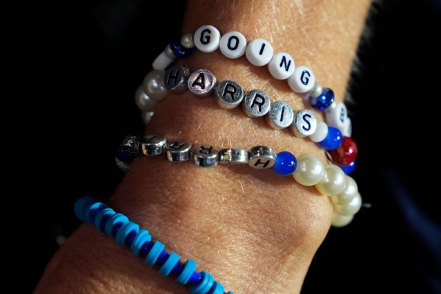 A supporter wears campaign-themed bracelets at a campaign rally for Democratic presidential nominee Vice President Kamala Harris at Erie Insurance Arena, in Erie, Pa., Monday, October 14, 2024. (Photo by Jacquelyn Martin/AP Photo)