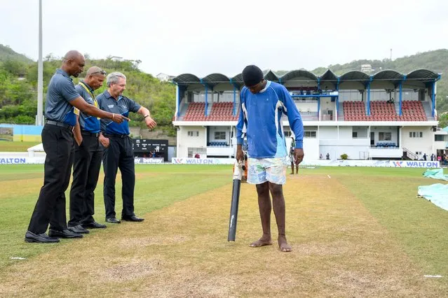 Match officials Gregory Brathwaite (L), Joel Wilson (2L) and Richard Illingworth (3L) inspect the pitch after rain delayed the start of the 4th day of the 2nd Test between Bangladesh and West Indies at Darren Sammy Cricket Ground, Gros Islet, Saint Lucia, on June 27, 2022. (Photo by Randy Brooks/AFP Photo)