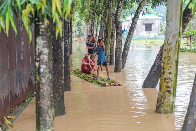 People use a raft as they search for relief after a widespread flash flood at Nalitabari sub district in Sherpur district, Bangladesh, 08 October 2024. (Photo by EPA/EFE/Stringer)