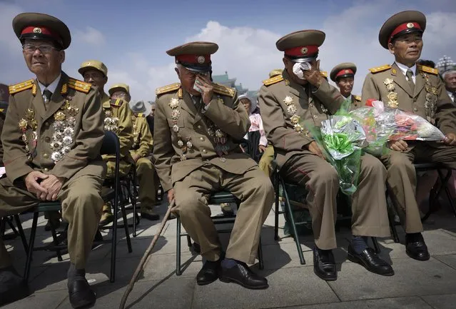 North Korean war veterans express varying degrees of emotion as they watch a parade celebrating the anniversary of the Korean War, Sunday, July 27, 2014, in Pyongyang, North Korea. (Photo by Wong Maye-E/AP Photo)