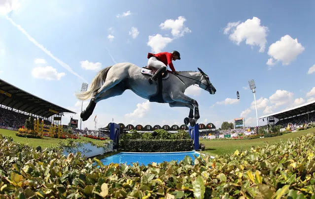 Ondrej Zvara of Czech Republic jumps with his horse Cento Lano over an obstacle in the first round of the Show Jumping Team Final Competition during the FEI European Championships in Aachen, Germany, 20 August 2015. (Photo by Friso Gentsch/EPA)