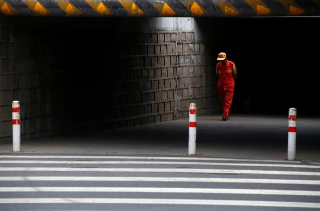 A street cleaner walks through an underpass in the outskirts of Beijing, China July 15, 2016. (Photo by Thomas Peter/Reuters)