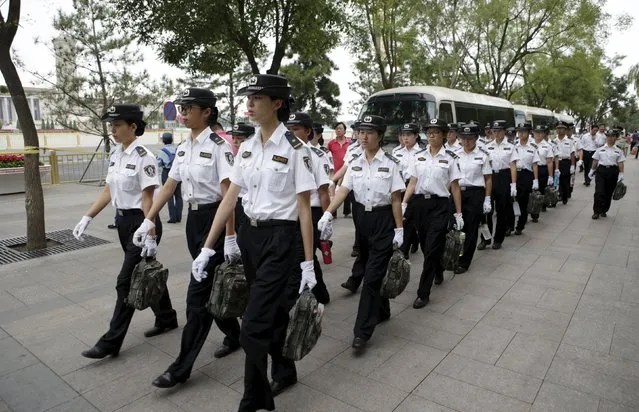 Female security staff arrive for their work next to Beijing's Tiananmen Square in the morning, August 30, 2015. Beijing is battening down the hatches and cranking up the propaganda ahead of a massive military parade this week to mark the end of World War Two, shooing cars from streets and shutting factories for the Communist Party's biggest event of the year. (Photo by Jason Lee/Reuters)