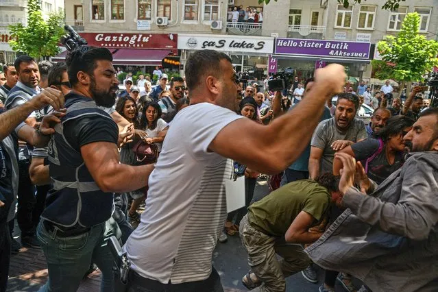 Demonstrators clash with Turkish police as they protest against the replacement of Kurdish mayors with state officials in three cities, in Diyarbakir, on August 19, 2019. The Turkish government removed three mayors from office on August 19, 2019 over alleged links to Kurdish militants, the interior ministry said. The mayors of Diyarbakir, Mardin and Van provinces in eastern Turkey – all members of the Peoples' Democratic Party (HDP) elected in March – were suspended. (Photo by Ilyas Akengin/AFP Photo)