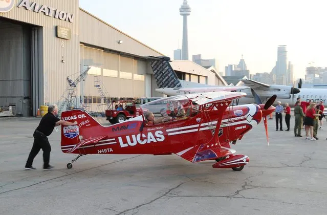 Aerobatic Pilot Mike Wiskus, in his Pitts Special Biplane, prepares for a media flight during media day for the Canadian International Air Show at Billy Bishop Airport, Toronto, Ontario, September 4, 2015. (Photo by Louis Nastro/Reuters)