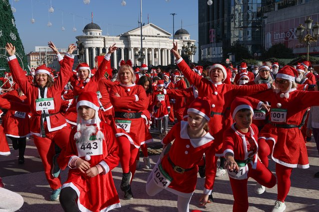 People dressed as Santa Claus warm up prior to the start of the traditional Santa race in Skopje, Republic of North Macedonia, 29 December 2024. (Photo by Georgi Licovski/EPA/EFE)
