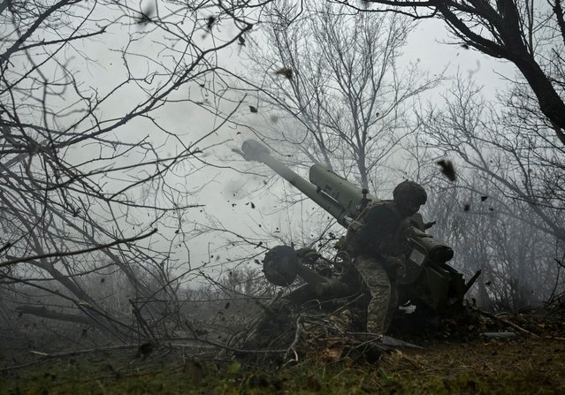 A serviceman of the artillery crew of the special unit National Police fires a D-30 howitzer towards Russian troops at a position in a front line, amid Russia's attack on Ukraine, in Zaporizhzhia region, Ukraine on January 11, 2025. (Photo by Reuters/Stringer)