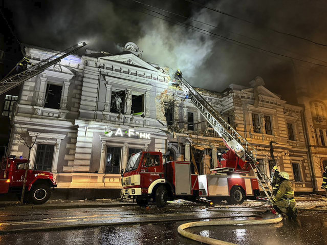 In this photo provided by the Ukrainian Emergency Service, firefighters put out a fire after a Russian missile attack in Kharkiv, Ukraine, Sunday, December 31, 2023. (Photo by Ukrainian Emergency Service via AP Photo)