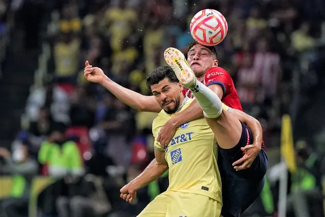 America's Henry Martin, front, and Guadalajara's Luis Olivas fight for the ball during a Mexican soccer league match at Azteca stadium in Mexico City, Saturday, September 17, 2022. America won 2-1. (Photo by Fernando Llano/AP Photo)