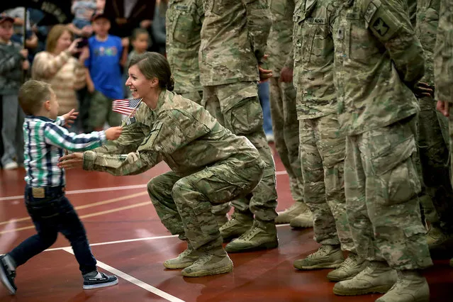 Cooper Waldvogel, 3, runs to hug his mother Kathryn Waldvogel after her return from Afghanistan at the Inver Grove Heights Training Center, Tuesday, September 16, 2014 in Inver Grove Heights, Minn.  More than 140 soldiers from the Minnesota National Guard's Chisholm-based 114th Transportation Company returned to Minnesota after a nine-month deployment to Afghanistan. (Photo by  Elizabeth Flores/AP Photo/The Star Tribune)