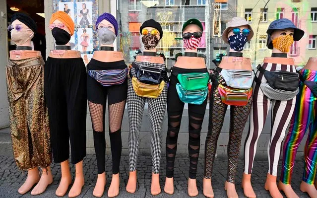 Face covers are on display outside a clothing store in Berlin on April 28, 2020 amid the new coronavirus COVID-19 pandemic. Masks are mandatory in shops across Germany from April 29, 2020, as medical experts warned the public to stay disciplined after official data offered a mixed picture on the battle against the novel coronavirus since Europe's biggest economy began a cautious easing of lockdown measures. (Photo by John MacDougall/AFP Photo)