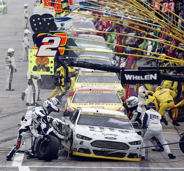 Brad Keselowski (2) leads cars in pit row during the NASCAR Sprint Cup series auto race at New Hampshire Motor Speedway, Sunday, September 21, 2014, in Loudon, N.H. (Photo by Jim Cole/AP Photo)